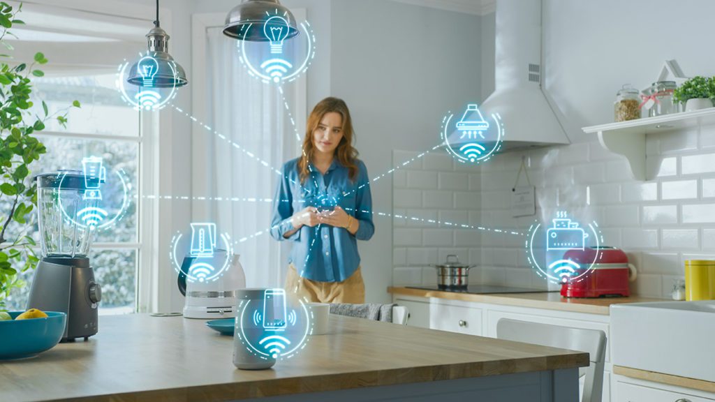 Woman in kitchen with several wi-fi enabled devices