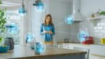 Woman in kitchen with several wi-fi enabled devices