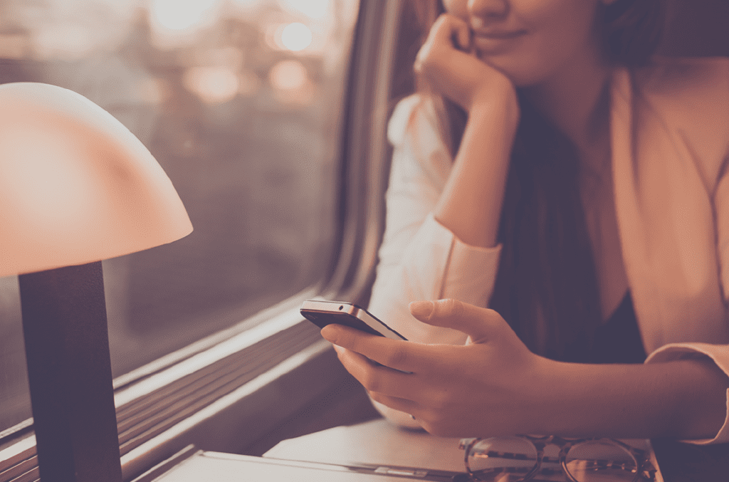 Woman on train looking at phone