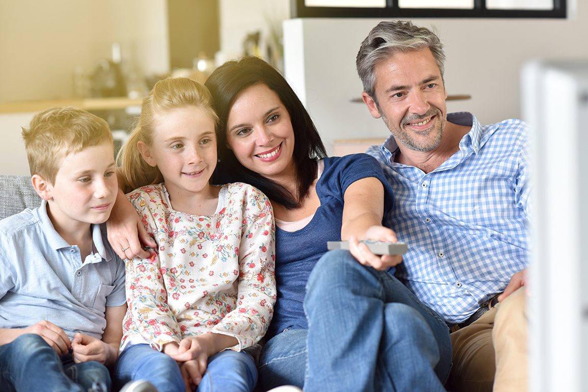 Family of four watching tv