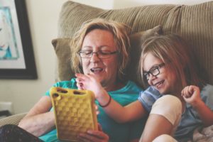 Woman and child looking at tablet.