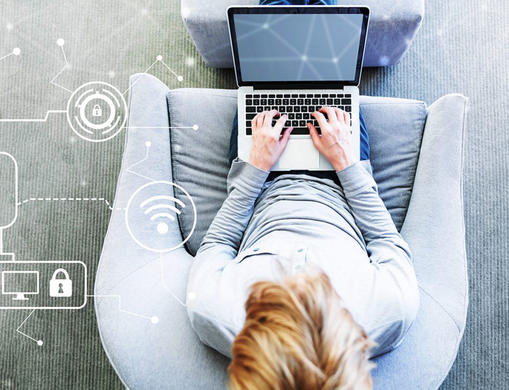 Person sitting on chair using laptop.