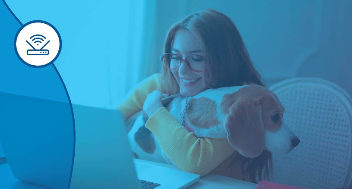 woman on laptop holding a dog