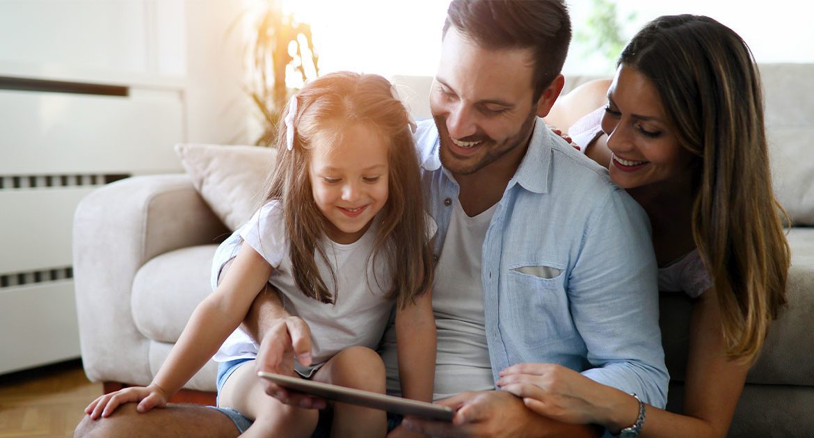 Small family looking at tablet.