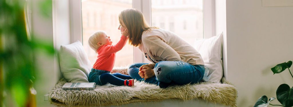 Small child touches mothers face.