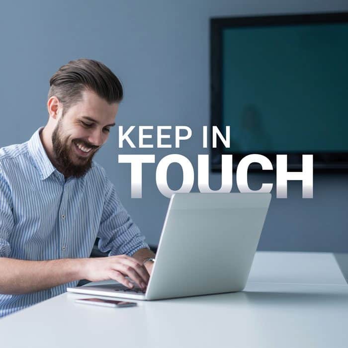 A man sitting at a table on his laptop