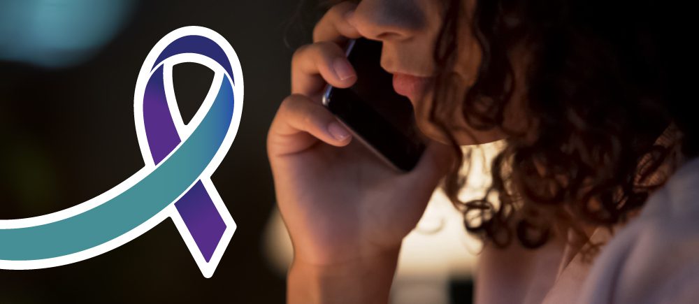 A girl talks on her cell phone with a graphic of the National Suicide Prevention Lifeline ribbon next to her.