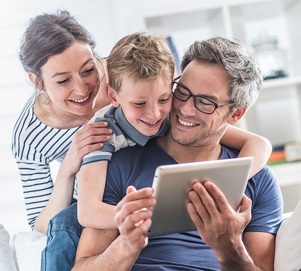 Young couple with son viewing something on a tablet.