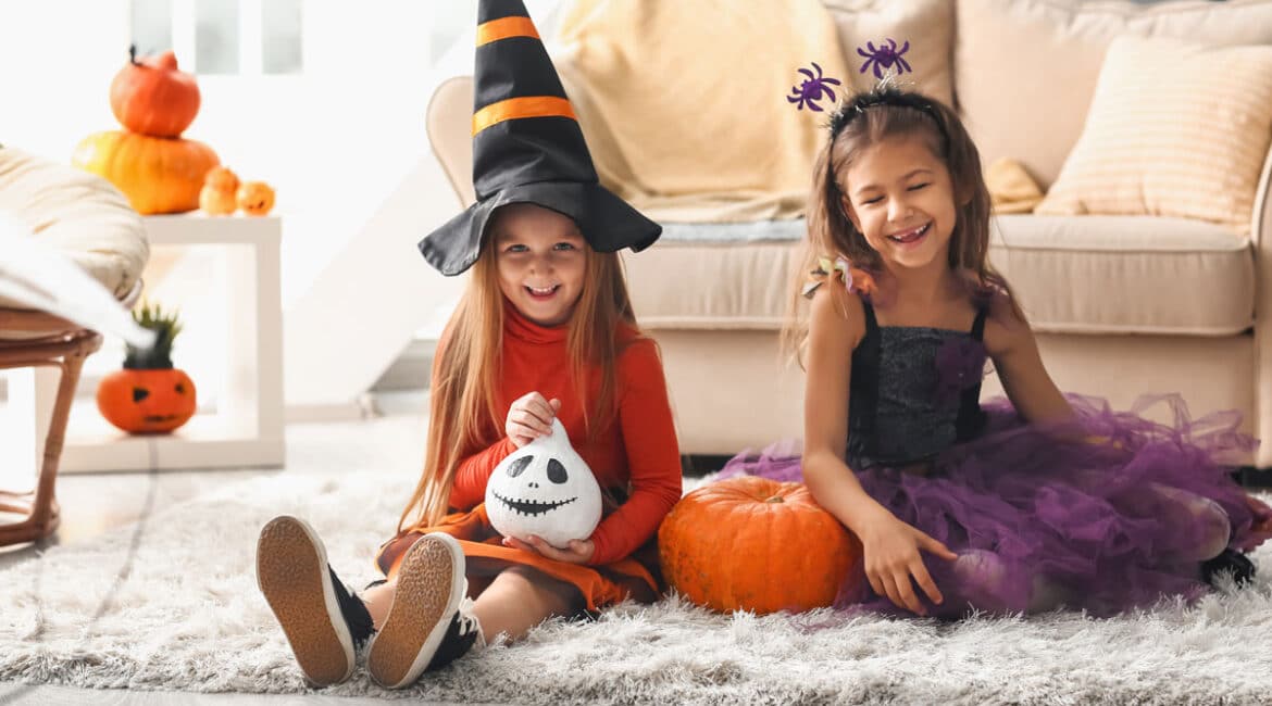 Two girls wearing Halloween costumes