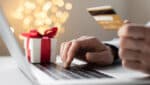 Holiday Scams - hands holding credit card while typing